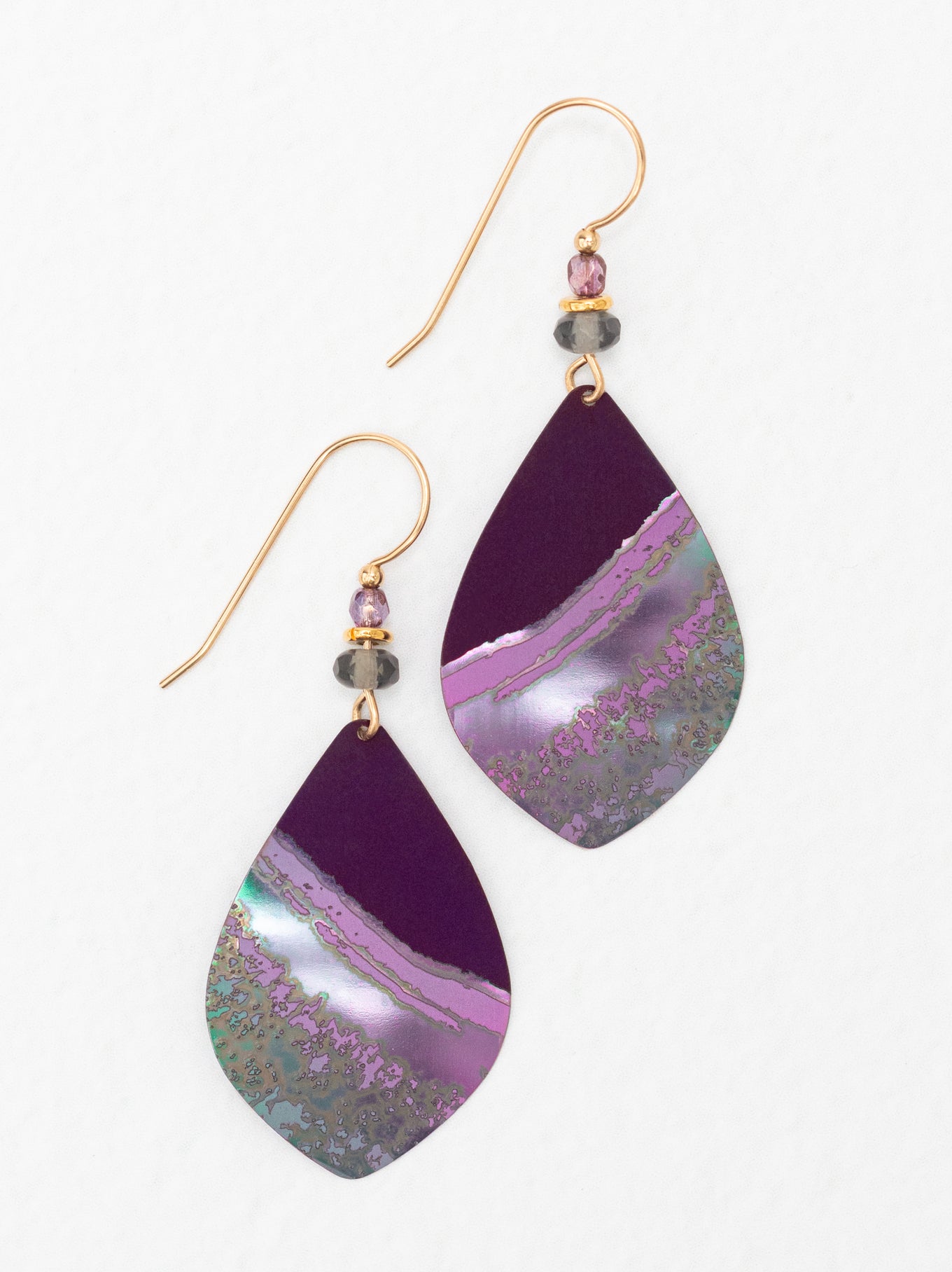 The niobium Shorebreak Earrings capture the colors of the sun and