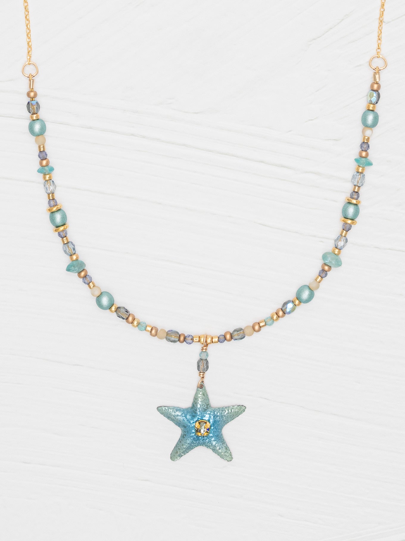 The Carmel Beaded Necklace features a niobium sea star pendant