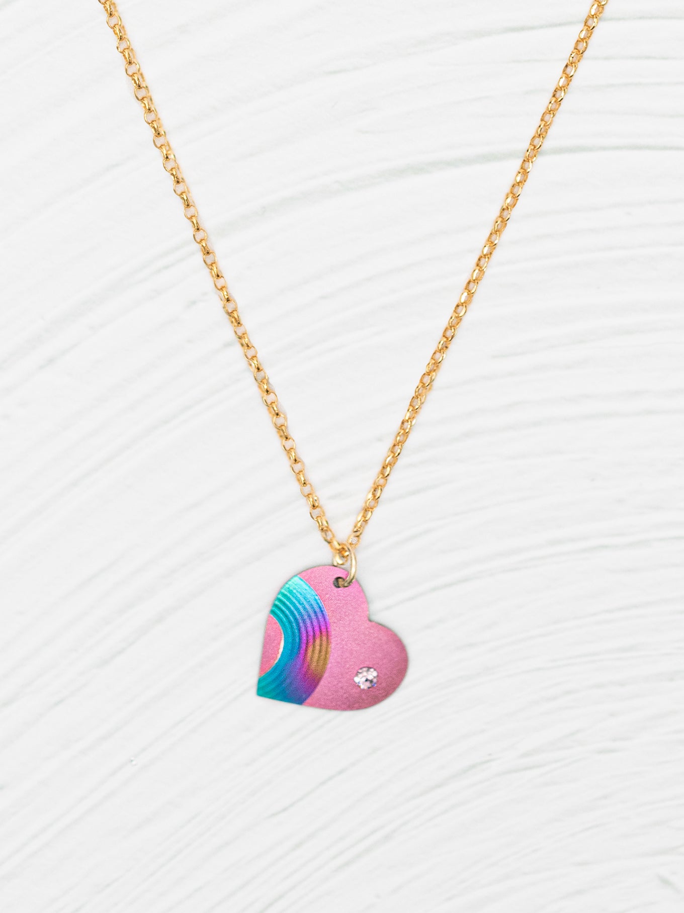 The Rainbow Heart Necklace For Kids is handcrafted in niobium