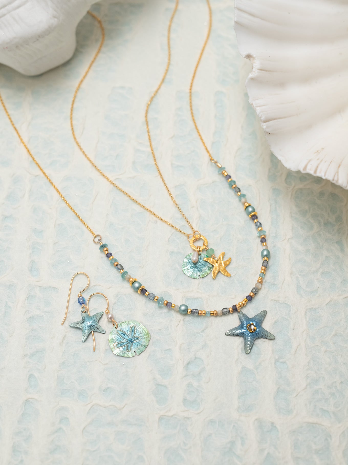 The Carmel Beaded Necklace features a niobium sea star pendant