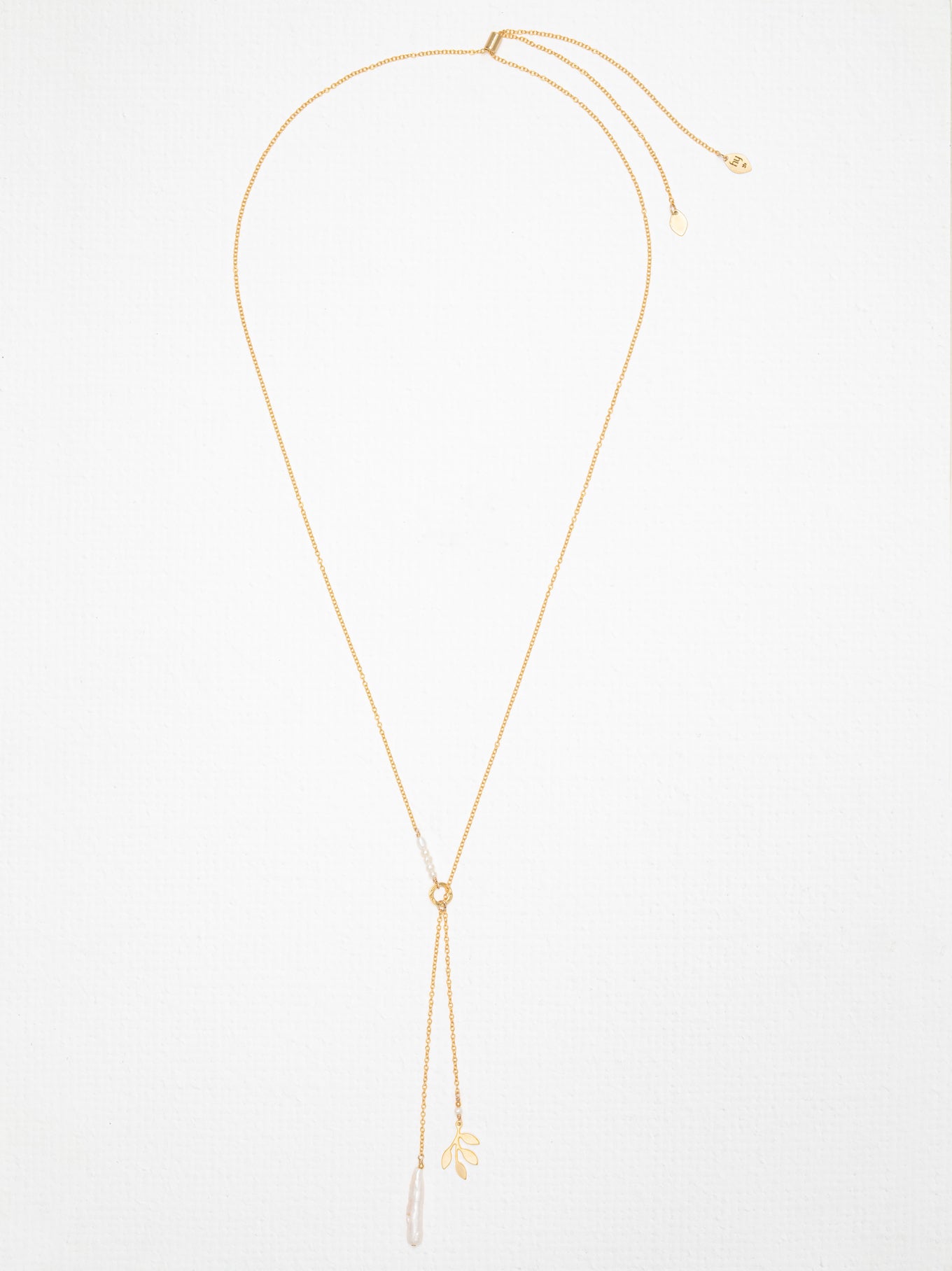 Lariat necklace shines with a pearl and the Holly Yashi four-leaf