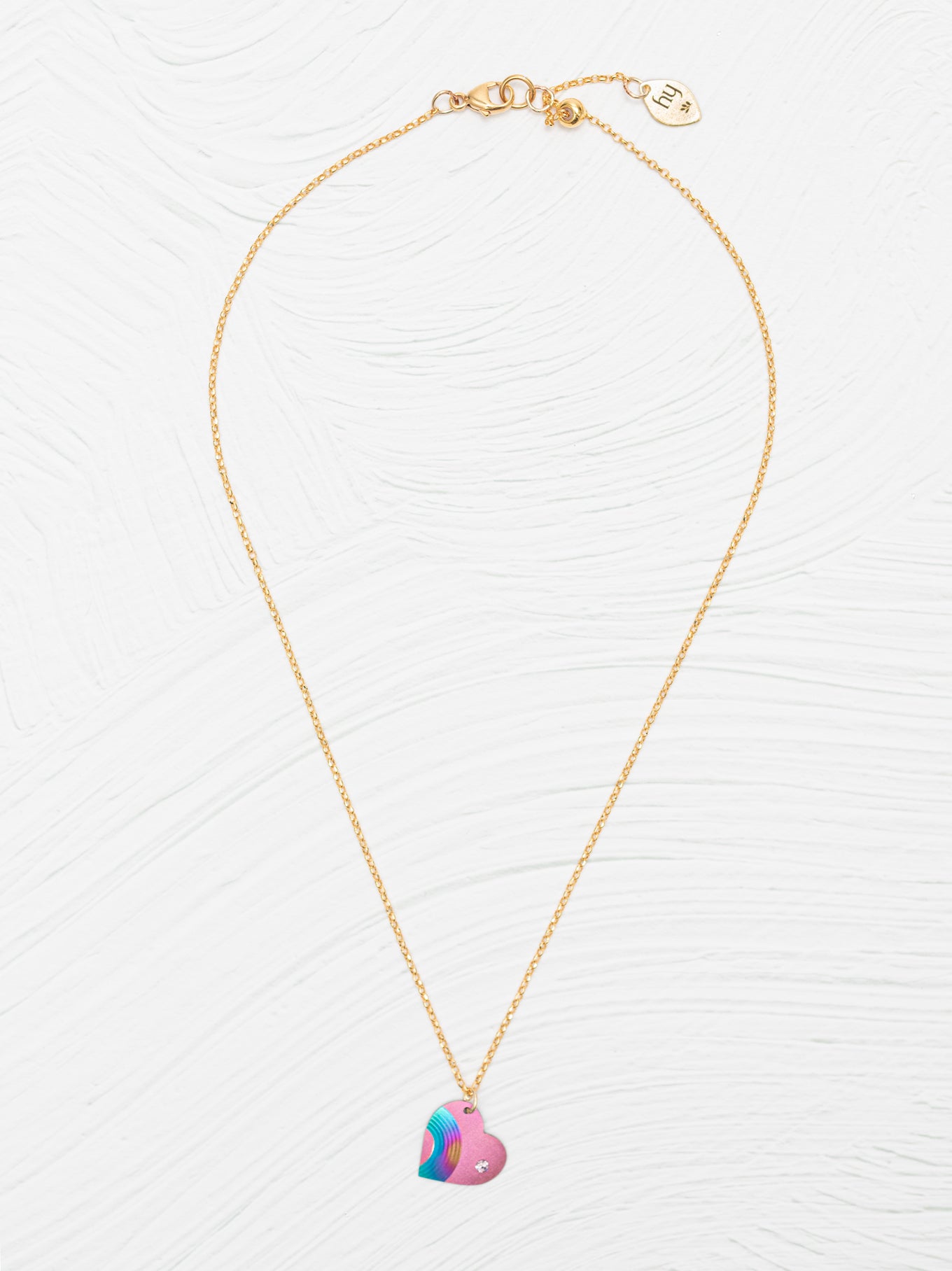 The Rainbow Heart Necklace For Kids is handcrafted in niobium