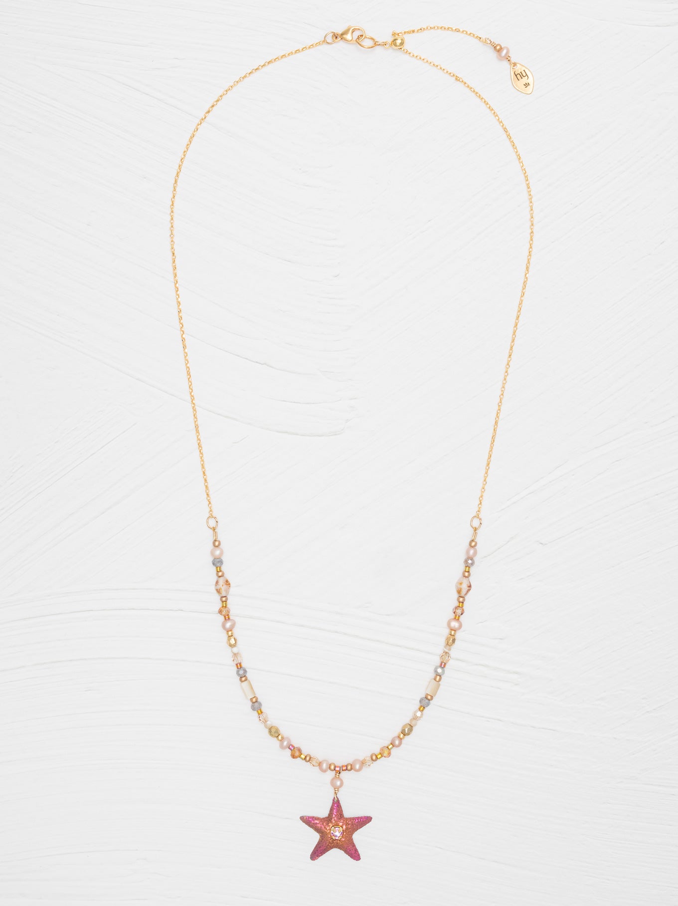 The Carmel Beaded Necklace features a niobium sea star pendant