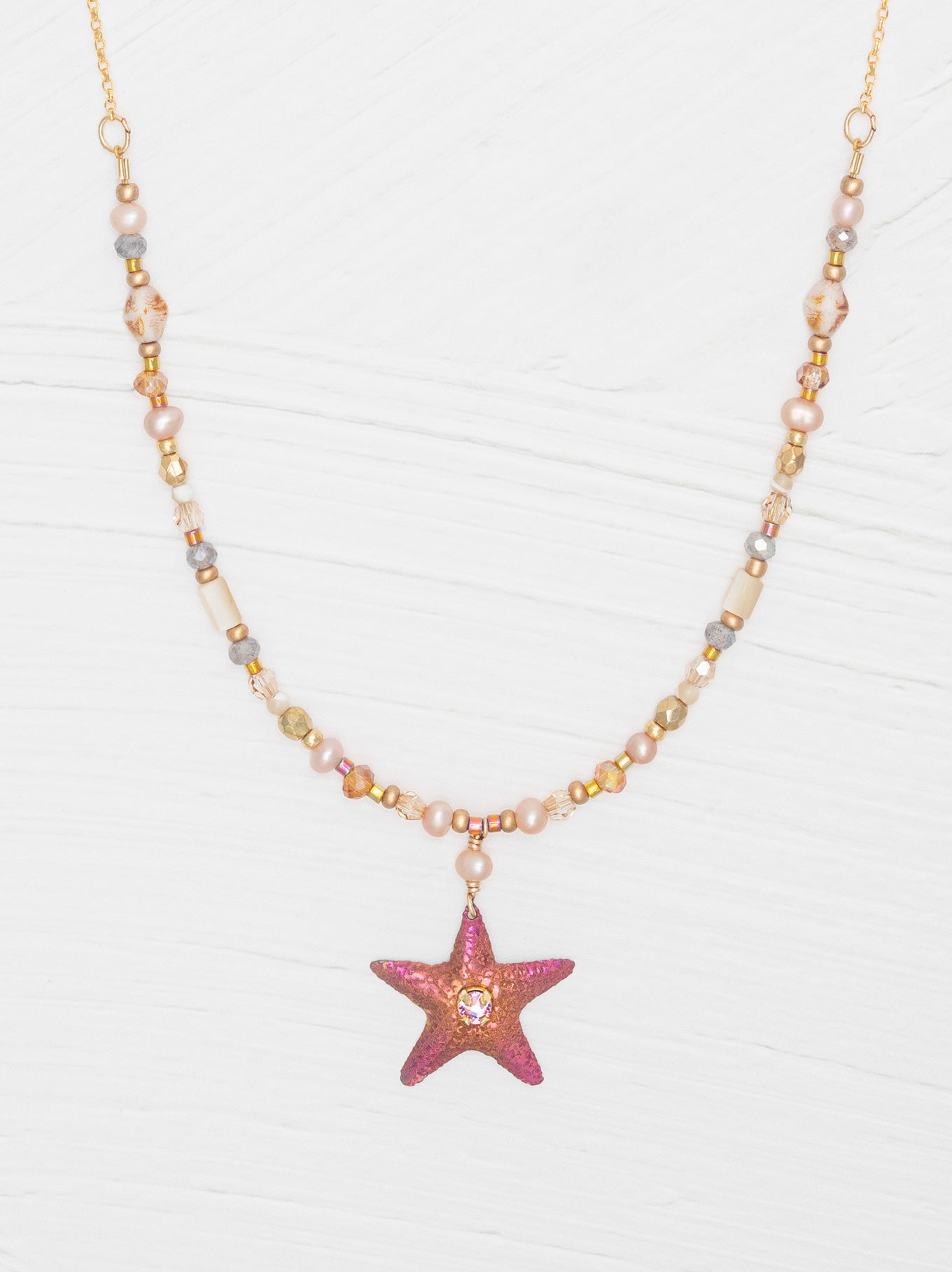 The Carmel Beaded Necklace features a niobium sea star pendant